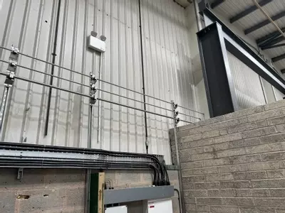 Part of the new pipework infrastructure installed at the Tamworth facility. This section shows three stacked pipework runs routed through the building &mdash; two high-pressure lines supplying the wash bay and one low-pressure feed serving the pressure washin